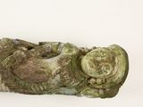 a statue of a person laying down on a white surface