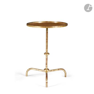 a round brass side table with a wooden top