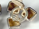 a pair of earrings that are sitting on a table