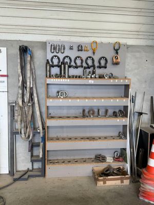a garage with a bunch of tools on the shelves