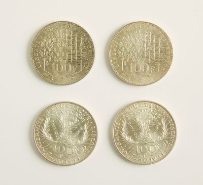 quatre types de pièces différents sont présentés sur une surface blanche