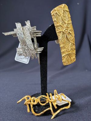 a close up of a metal object with a piece of gold on it