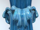 a blue vase that has a handle on it