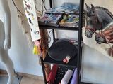 a shelf with various items on it and a mannequin