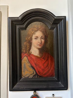 a picture of a painting on the wall above a clock