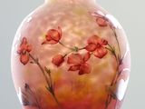 a glass vase with flowers painted on it sitting on a table