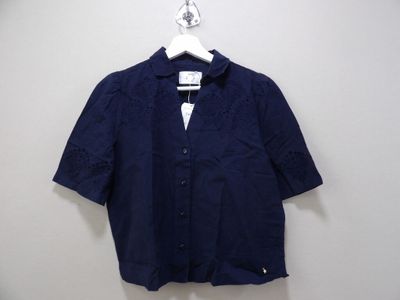 un gros plan d'une chemise suspendue à un cintre accroché au mur