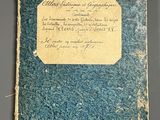 an old book with writing on it sitting on top of a table