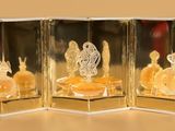 three glass figurines that are sitting on a table