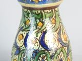 a small vase with a blue and yellow design on it