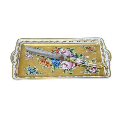 a tray with a knife on it with flowers on it