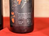three bottles of wine sitting on a red cloth