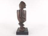 a wooden sculpture of a man with a hat on his head