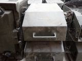a pile of old appliances sitting on a pallet in a warehouse