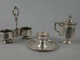three pieces of silverware including a teapot, cup and saucer