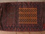 an old rug on the floor with a brown and red design