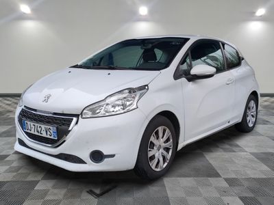 the small white car is parked in a room with a checkered floor