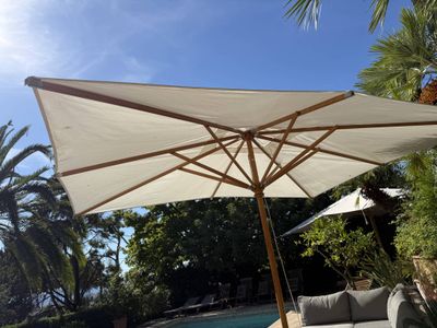 a large umbrella that is sitting on a patio