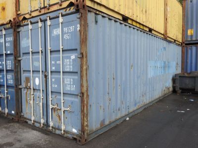 a blue and yellow shipping container sitting in a parking lot