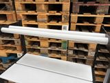 a white bench sitting in front of a stack of pallets