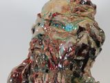 a ceramic sculpture of a man ' s head on a white surface