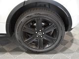 a close up of a tire on a white car