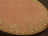 a gold and white table with flowers on it