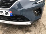 a close up of the front bumper of a blue car