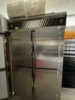 two stainless steel refrigerators that are in a kitchen