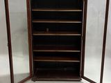 an image of a wooden cabinet with glass doors