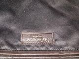 the back of a black bag with a leather label on it