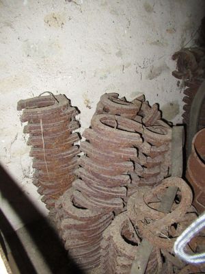a pile of rusted gears sitting in a room