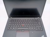 the laptop is open on a white surface with a black keyboard