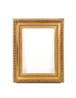 a gold picture frame on a white wall with a white background