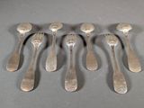 six silver spoons are arranged in a row on a gray surface