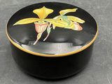 a black box with a yellow flower painted on it