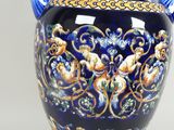 a large blue vase with a gold and blue decoration on it