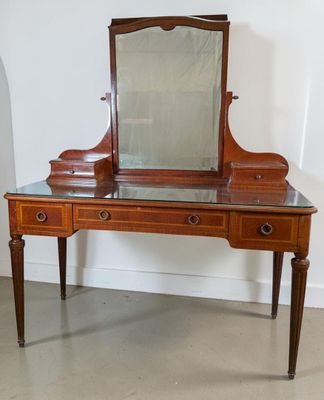 a wooden vanity with a mirror on top of it