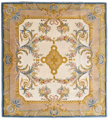 a beige and blue rug with a floral design on it