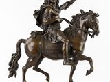 statue of a man on a horse with a sword on a marble base