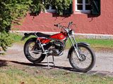 a red motorcycle parked on the side of the road