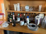 a wooden shelf with many bottles and glasses on it