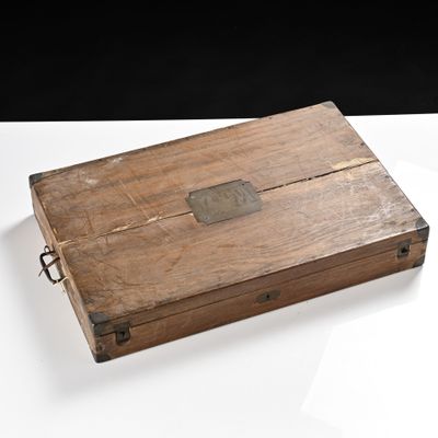 an old wooden box with a metal latch on it