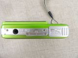 a green cell phone that is sitting on a table