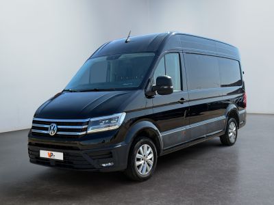 the black van is parked in a room with a white wall