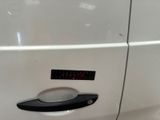 a close up of a door handle on a white car