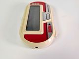 a red and white cell phone sitting on a white surface