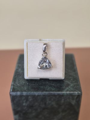 silver plated pendant with a heart shaped diamond on top of a white box