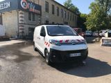 a white van that is parked in front of a building