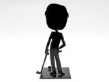 a black and white photo of a figurine of a man with a baseball bat